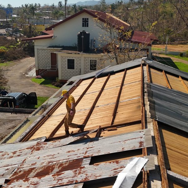 Volunteers work on roof repairs